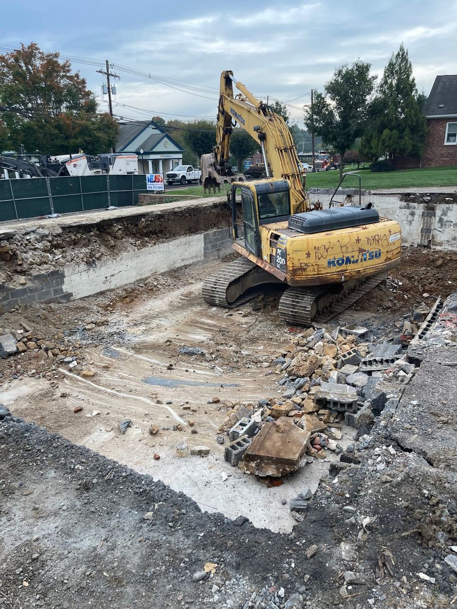 Excavator demolishing the existing structure on the Randolph site
